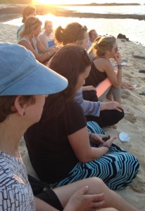 attendees sitting on the beach